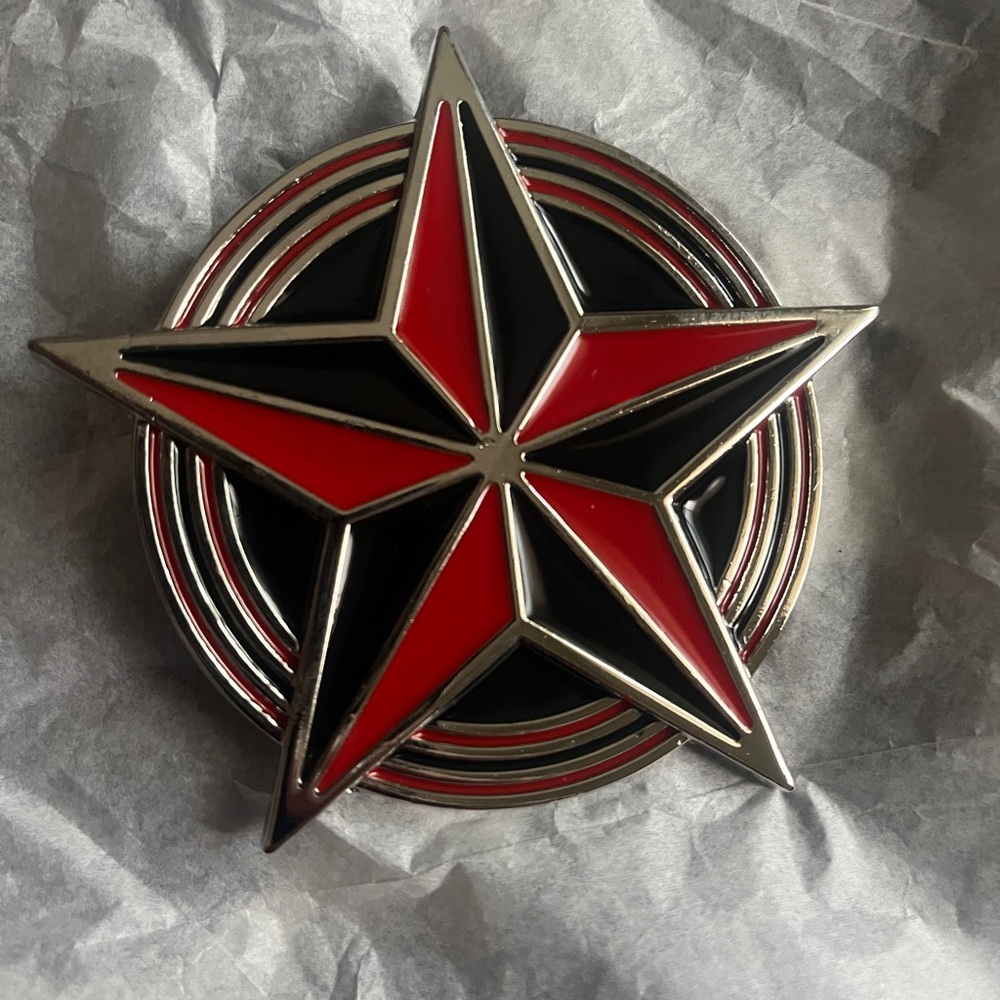 New nautical star belt buckle, often described as a red and black enamel star